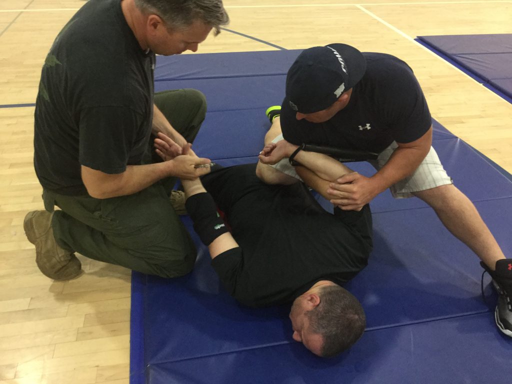 Man face down on the mat after being restrained.